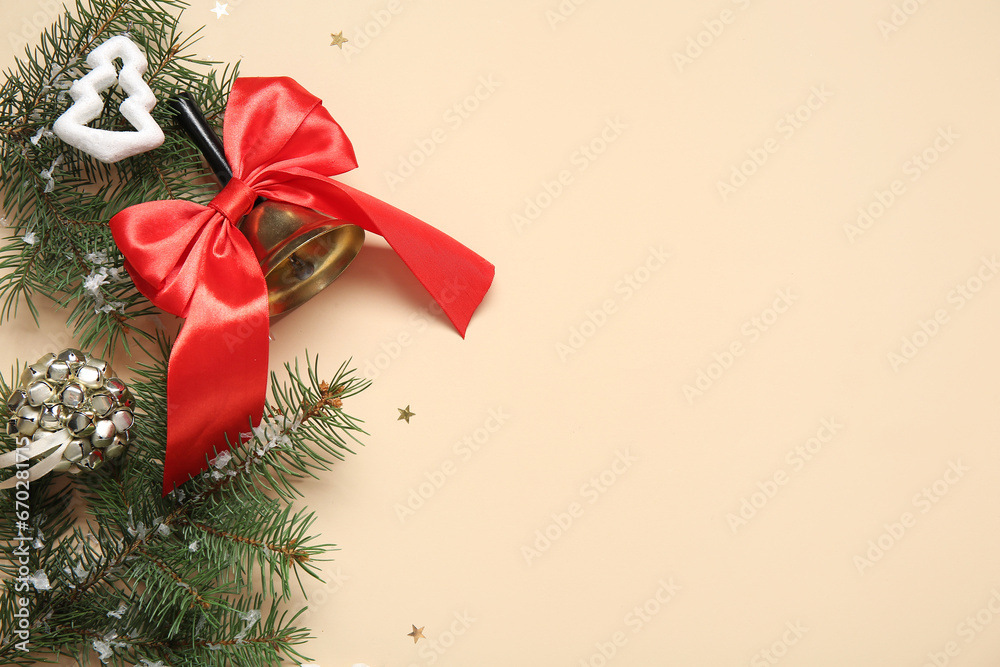 Christmas bell with fir branches and beautiful decorations on beige background