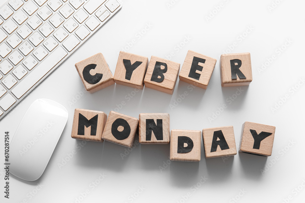 Text CYBER MONDAY made of wooden cubes, computer mouse and keyboard on light background