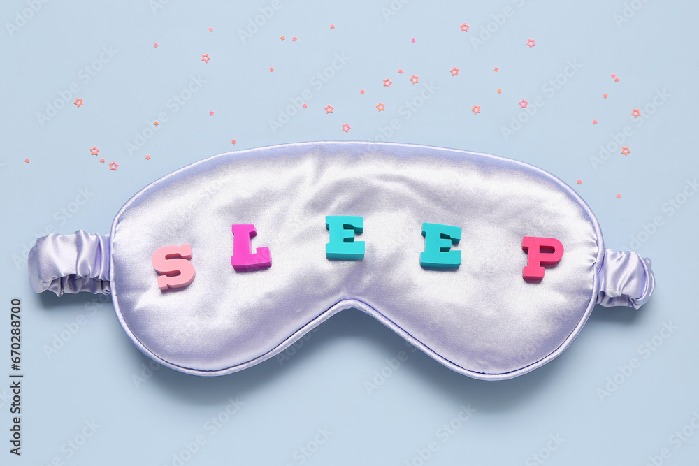 Composition with sleep mask, word SLEEP and sequins on color background