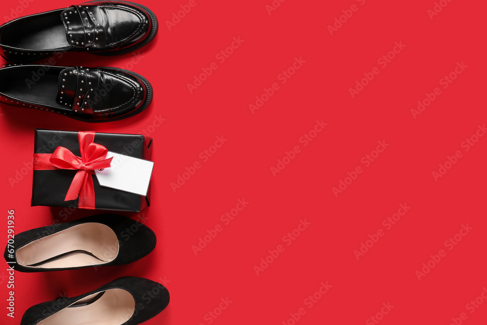 Stylish female shoes and gift box with blank tag on red background. Black Friday sale