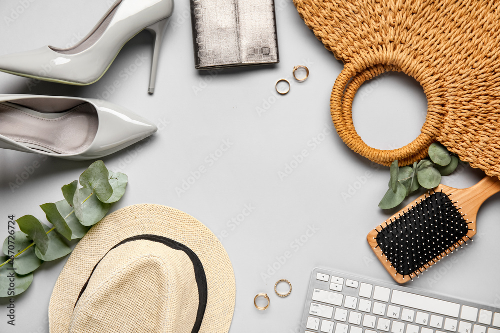 Frame made of stylish female shoes, accessories and keyboard on light background