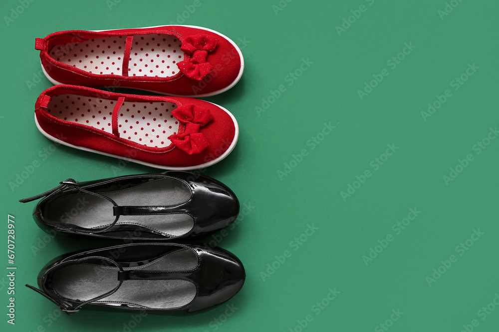 Stylish childs shoes on green background