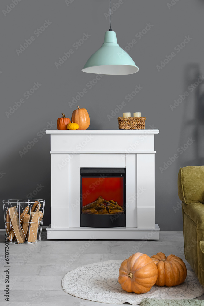 Interior of living room with electric fireplace and pumpkins