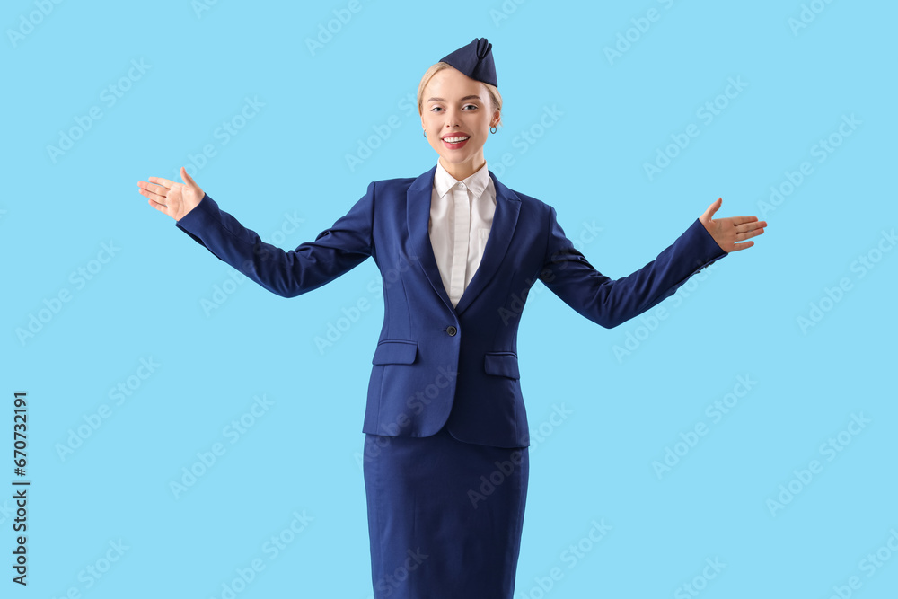 Young stewardess on blue background