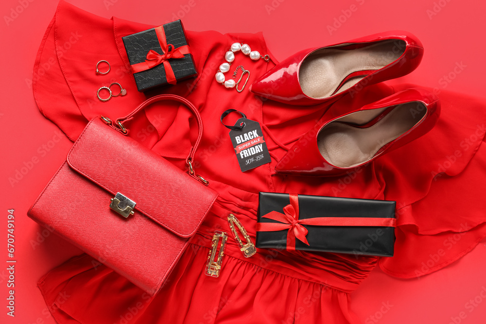 Composition with stylish female clothes, accessories, shoes and gifts on red background. Black Friday sale