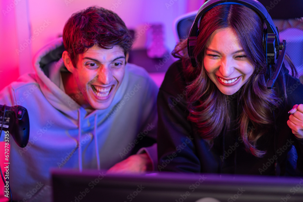 Caucasian Esport couple gamer playing online video game on computer. 