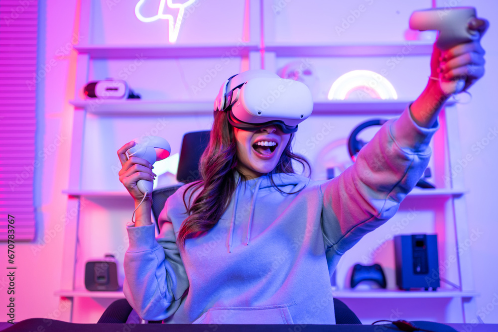 Asian young esport woman gamer use technology VR glasses and play game. 