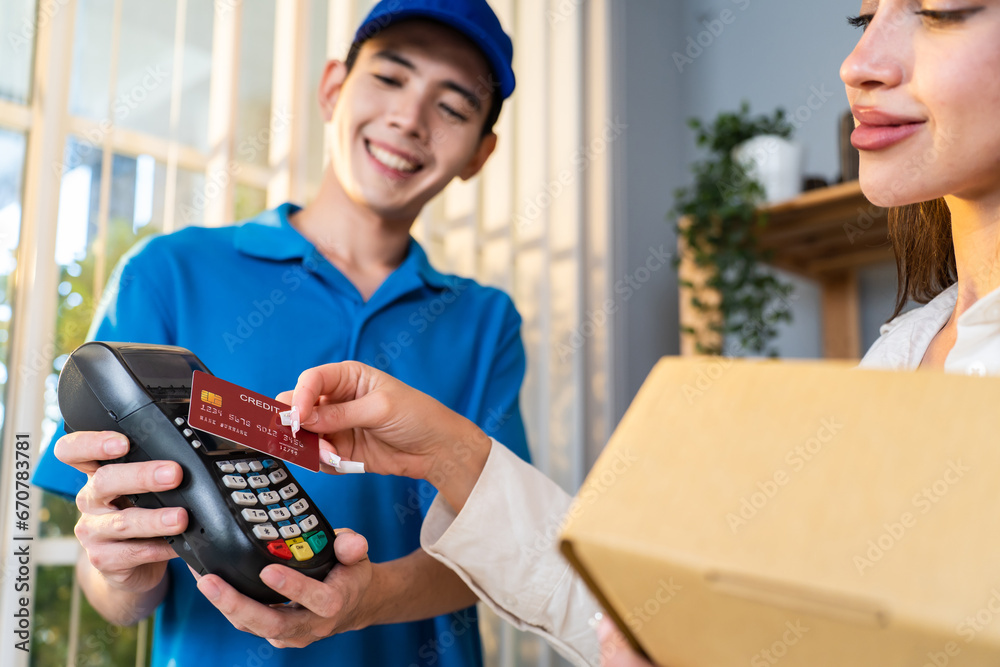 Caucasian young woman receive a box form deliverly man in store house.