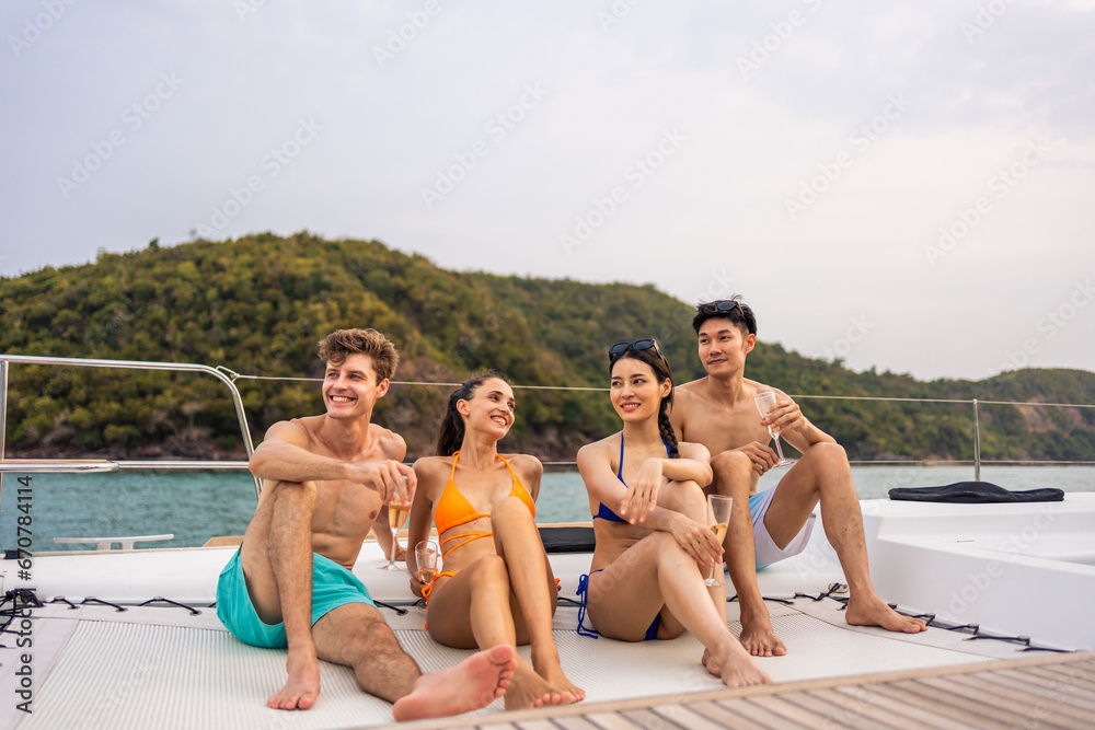 Group of diverse friends drink champagne while having a party in yacht. 