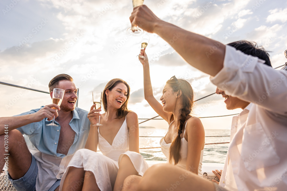 Group of diverse friends drink champagne while having a party in yacht. 