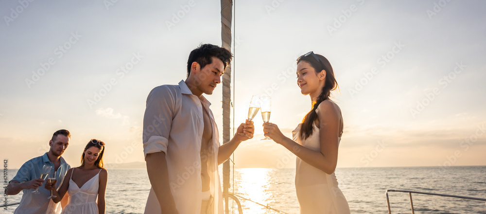 Asian beautiful couple drinking champagne while having party in yacht.