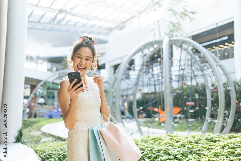 Asian beautiful woman use smartphone and shopping in department store. 