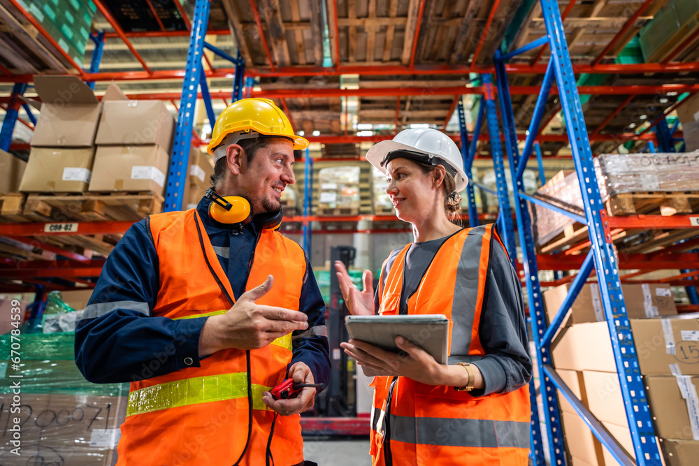 Caucasian man and woman industrial worker work in manufacturing plant. 