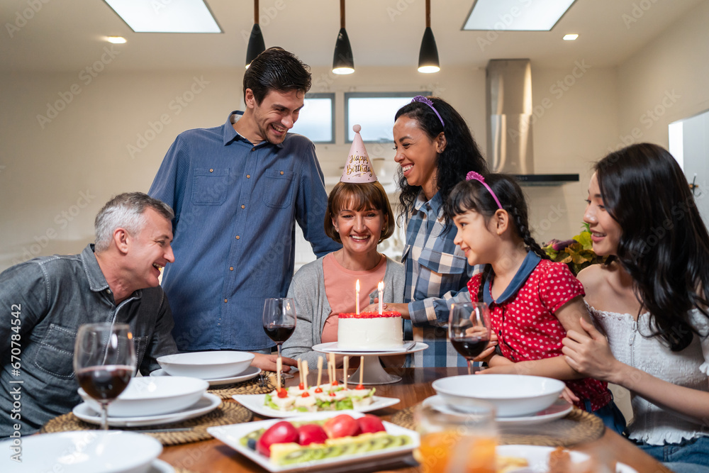 Multi-ethnic big family having birthday party for senior grandmother. 