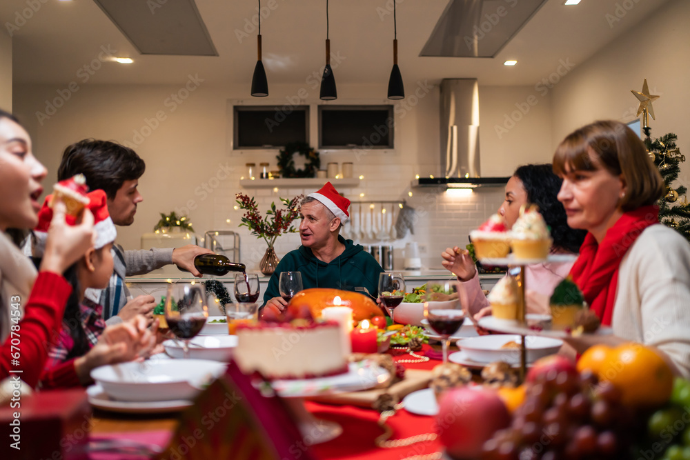 Multi-ethnic big family celebrating Christmas party together in house. 