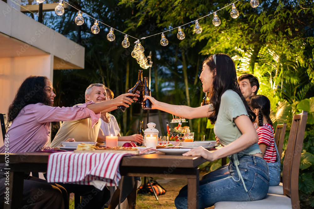 Multi-ethnic big family having fun, enjoy party outdoors in the garden.