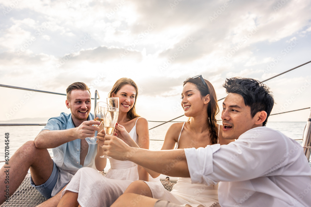 Group of diverse friends drink champagne while having a party in yacht. 