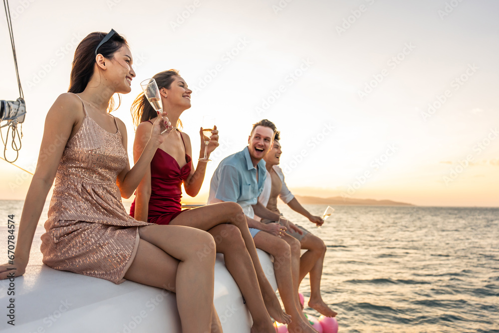 Group of diverse friends drink champagne while having a party in yacht.