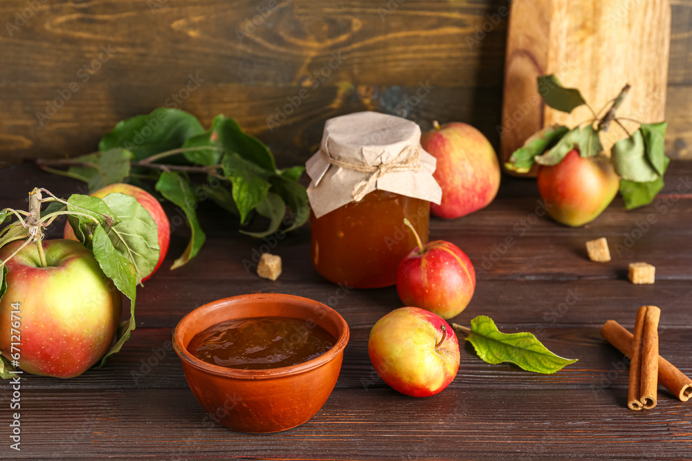 Bowl of apple jam, fresh fruits and spices on wooden table