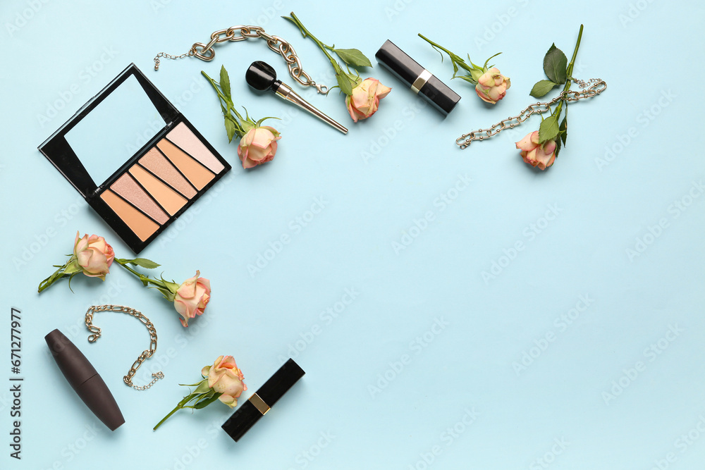 Composition with makeup products, jewelry and beautiful rose flowers on blue background