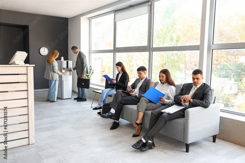 Business people waiting for their turn in office hall