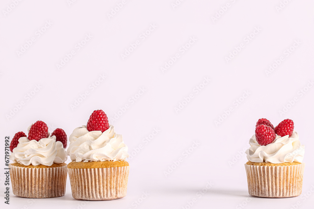 Tasty raspberry cupcakes on grey background