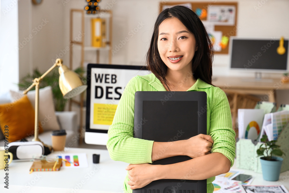 Asian interior designer with graphic tablet in office