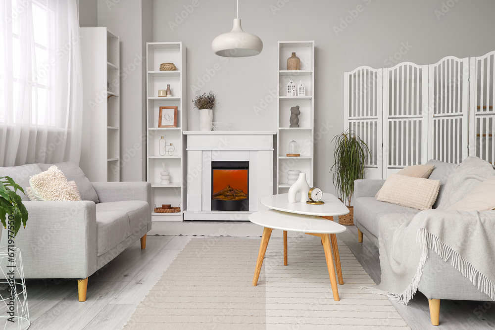 Modern fireplace with shelving units and sofas in living room