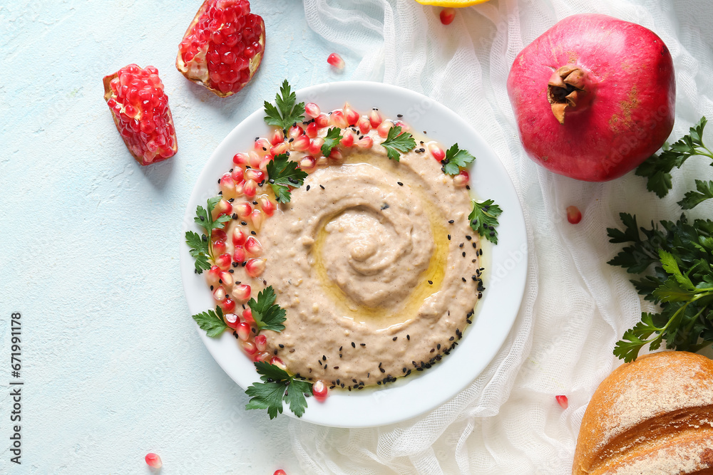 Plate of tasty baba ghanoush on white background