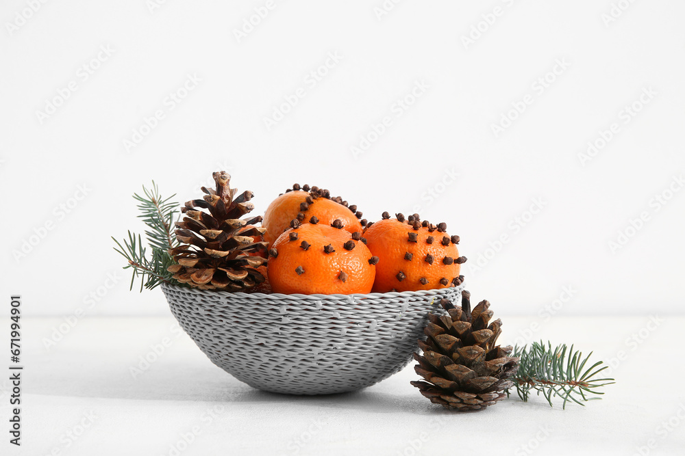 Bowl with pomander balls and Christmas tree branches on white background