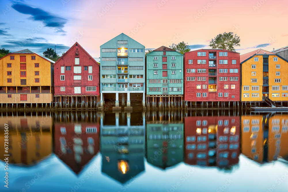 Colorful old houses over the Nidelva river at summer sunset in Trondheim, Norway