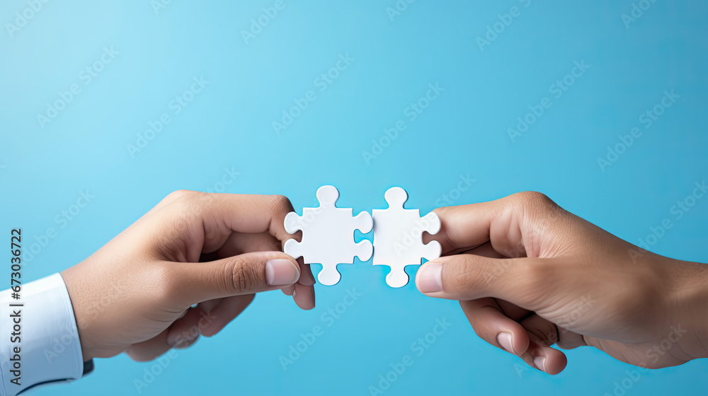 Concept of business,hands holding a jigsaw puzzle on pastel blue background