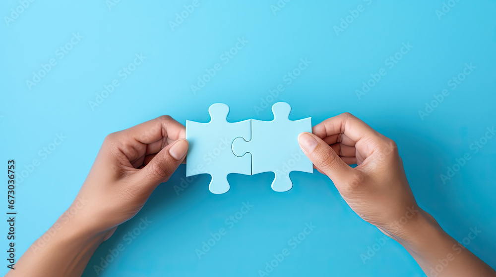 Concept of business,hands holding a jigsaw puzzle on pastel blue background