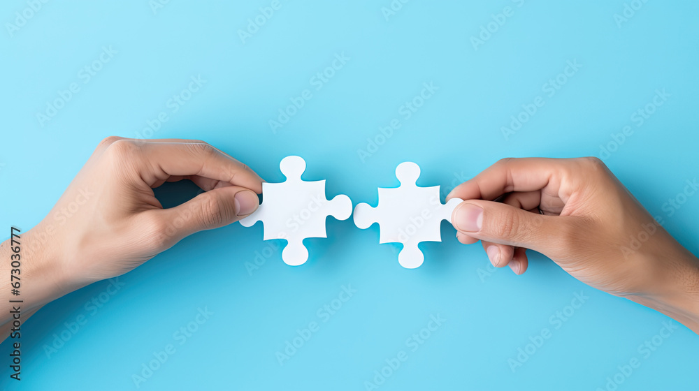 Concept of business,hands holding a jigsaw puzzle on pastel blue background