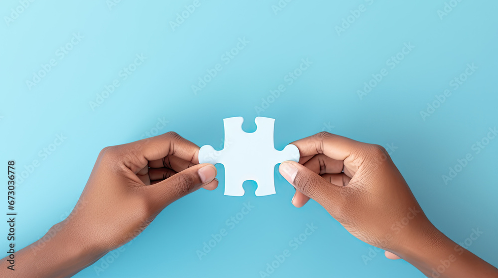 Concept of business,hands holding a jigsaw puzzle on pastel blue background