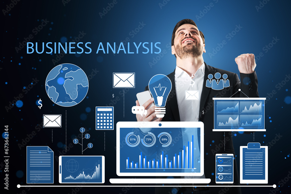 Attractive young european businessman celebrating success with financial data and accounting hologram with devices and charts on blue background. Statistic research and technology concept.