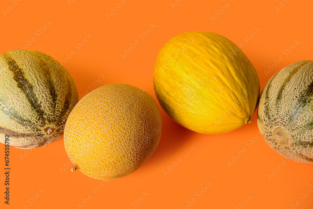 Different sweet melons on orange background