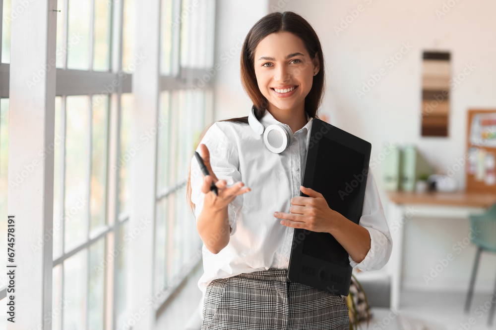 Female interior designer with graphic tablet in office