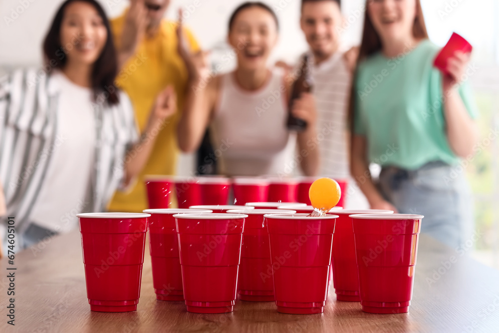 Cups for beer pong on table at party, closeup