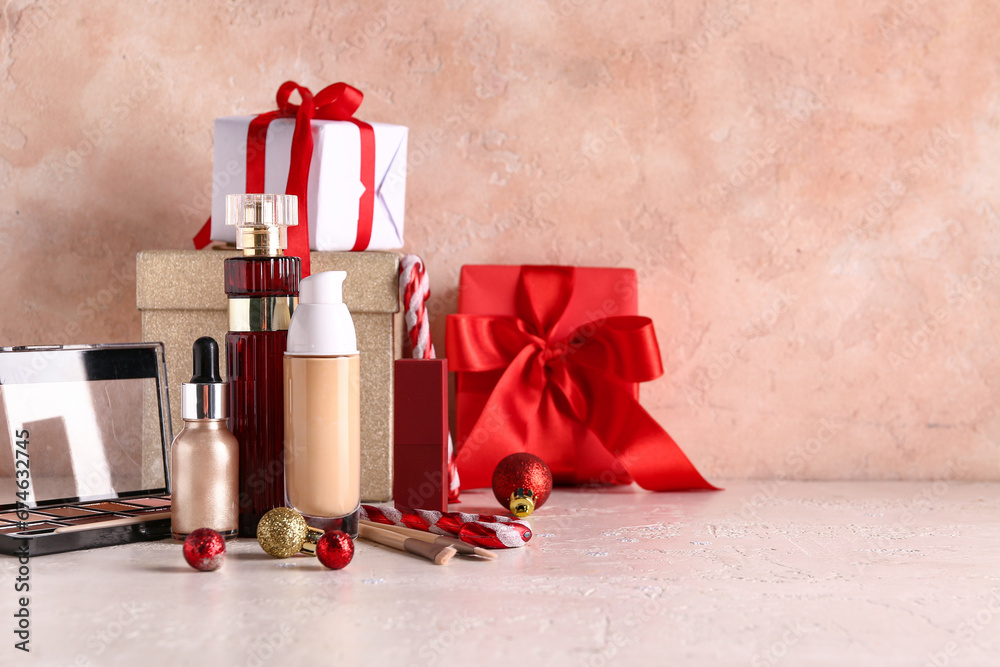 Christmas composition with makeup products on light background