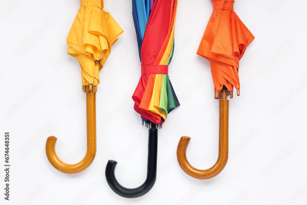 Different stylish umbrellas on white background