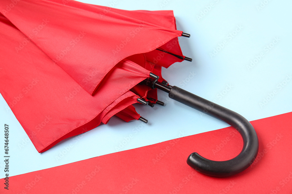 Red stylish umbrella on colorful background