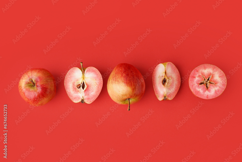 Sweet pink apples on red background