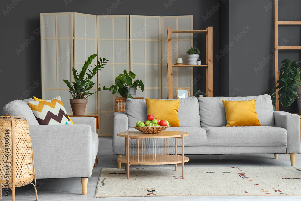 Interior of modern living room with sofas and apples on table