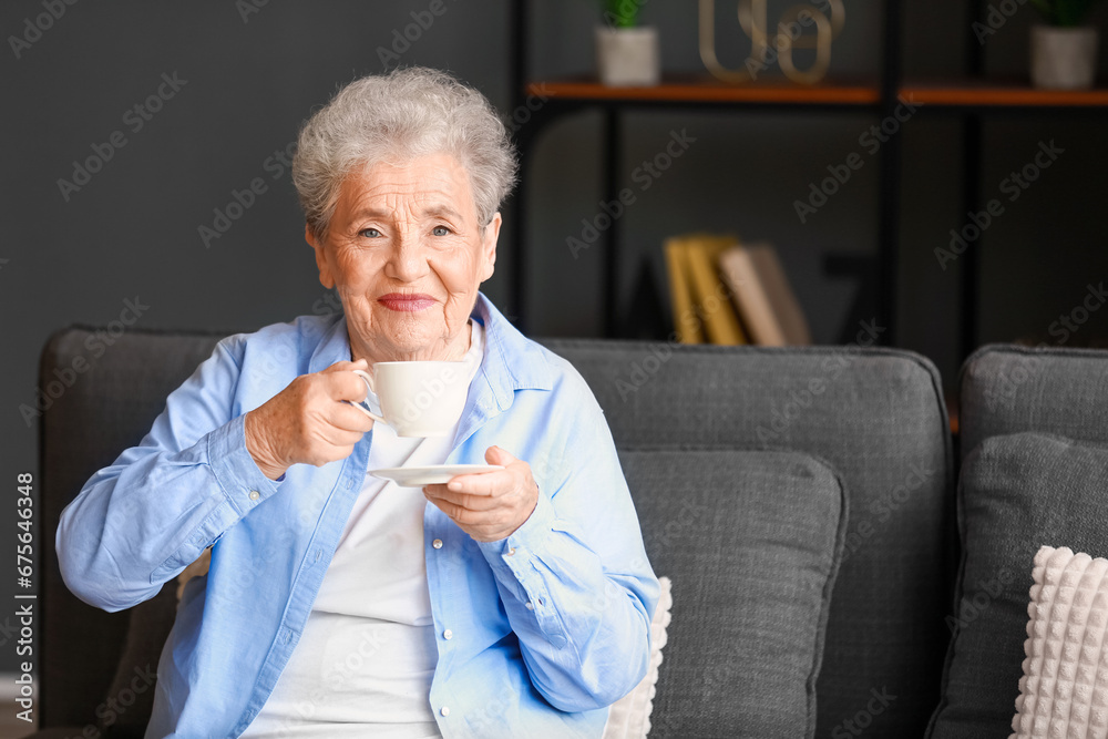 Senior woman with cup of coffee at home