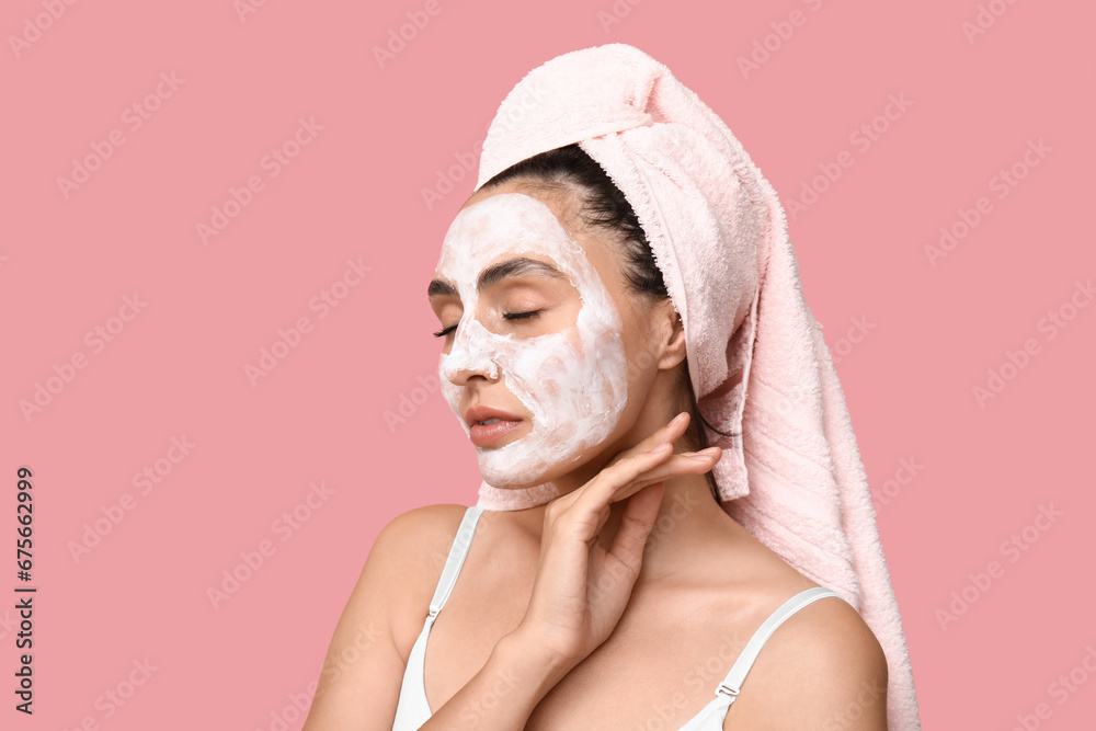 Young woman with applied mask on pink background, closeup