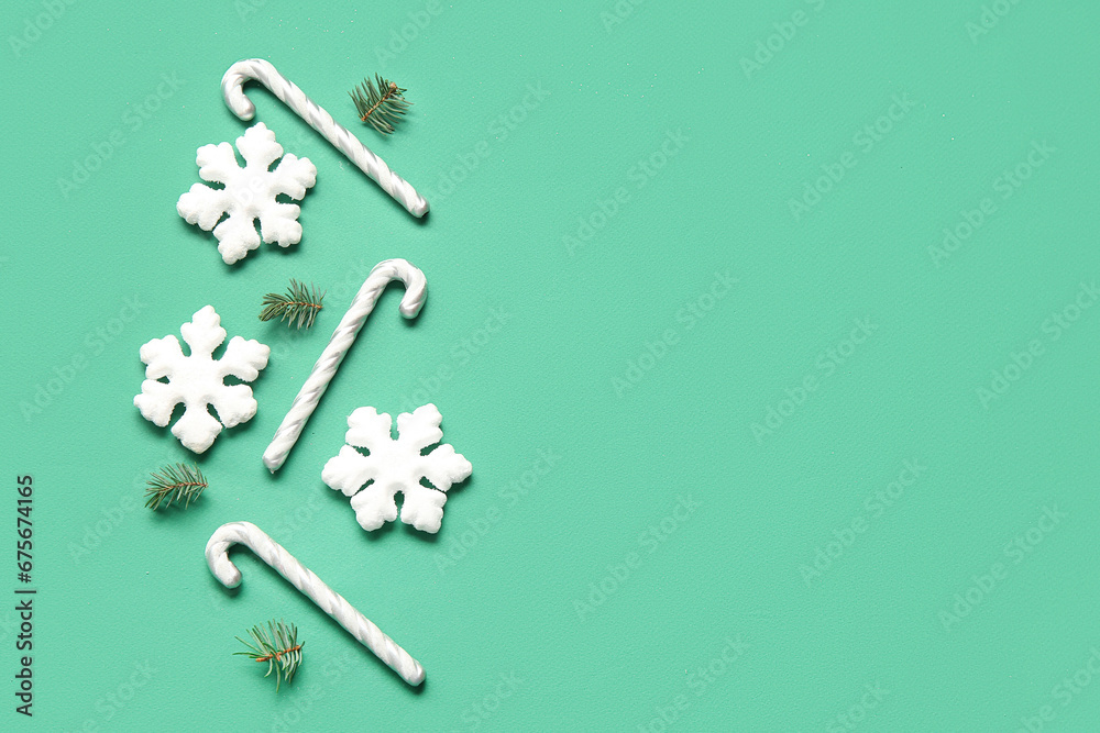 Beautiful snowflakes with fir branches and candy canes on green background