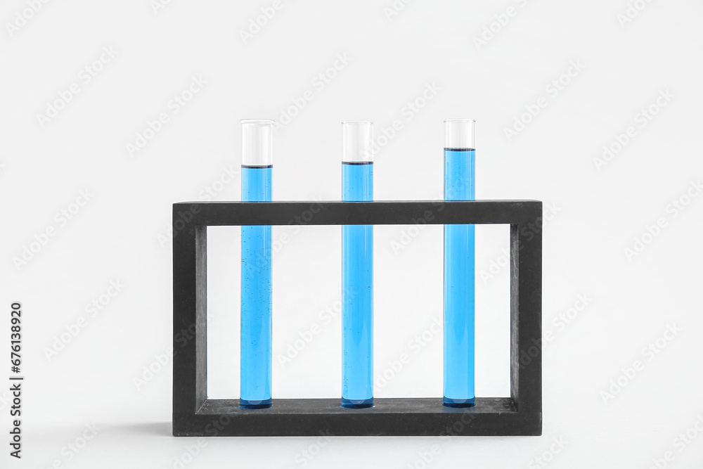 Test tubes with samples in stand on grey background