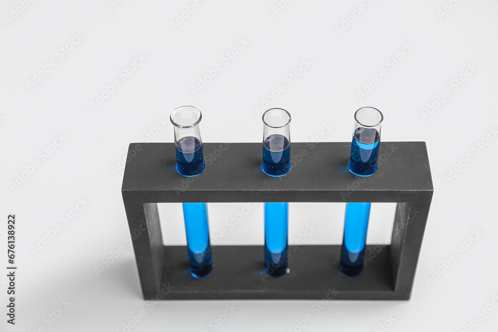 Test tubes with samples in stand on grey background