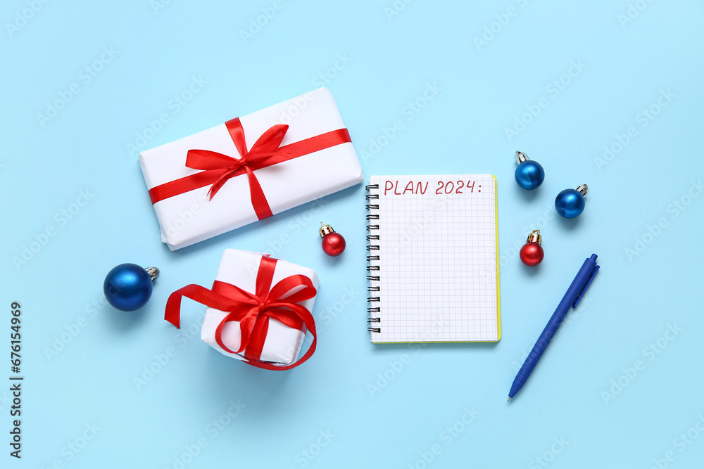 Notebook with text PLAN 2024, pen, Christmas balls and gift boxes on blue background